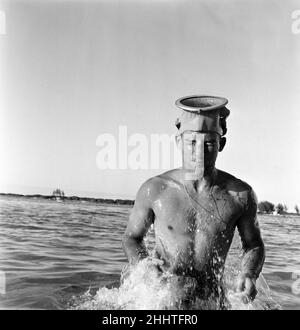 Stirling Moss se mettre en forme en ski nautique sur la plage de Nassau.Il se prépare pour une course de douze heures à Sebring, en Floride, le 12th mars.10th mars 1955. Banque D'Images