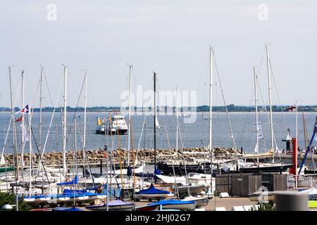 Voiliers amarrés à la jetée avec remorqueur en arrière-plan vu du centre de voile de l'Université de Kiel en été. Ciel bleu clair. Banque D'Images