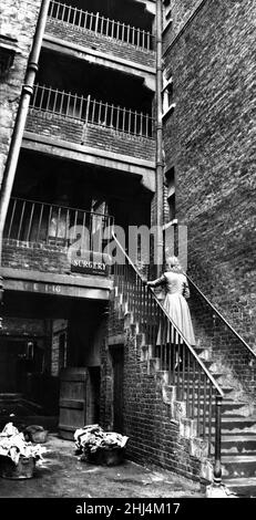 Modèle posé photographie de la femme entrant dans un bidonville chirurgie, Back Street avortement Clinic, Londres, 17th janvier 1958.Publié dans Women's Sunday Mirror 19th janvier 1958. Banque D'Images