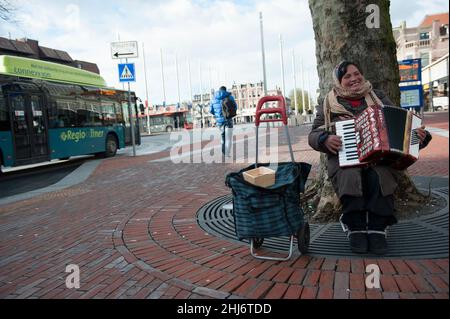 Haarlem, pays-Bas.Roma femme jouant son accordéon sur une place de la gare pour gagner un dollar ou deux par jour.Des hommes et des femmes roms sont transportés en masse dans les pays d'Europe occidentale pour gagner des pourboires et des coupures d'argent de différentes manières pour soutenir leur vie dans la pauvreté et les groupes de trafic d'Huma qui les amènent à l'Occident. Banque D'Images