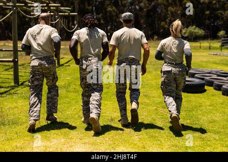 Vue arrière d'un groupe de soldats divers hommes et femmes qui s'exécutent ensemble au camp de chaussures Banque D'Images