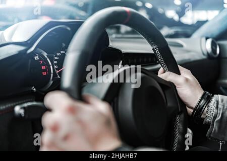 Conducteur de véhicule de performance caucasien.Mains sur le volant.Thème automobile. Banque D'Images