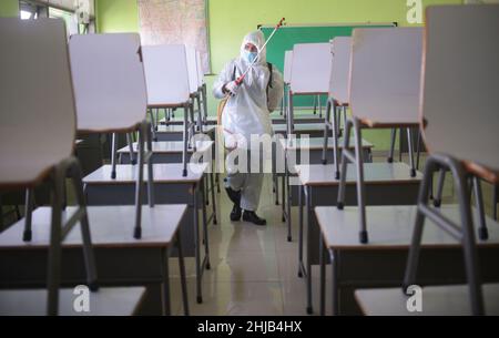 Jakarta, Indonésie.28th janvier 2022.Un membre de la Société indonésienne de la Croix-Rouge procède à la désinfection dans un bâtiment scolaire de Jakarta, en Indonésie, le 28 janvier 2022.L'Indonésie a confirmé jeudi 8 077 nouveaux cas de COVID-19, soit la plus forte augmentation d'un jour depuis le 2 septembre 2021, dans le contexte de la propagation de la variante Omicron dans le pays.Credit: Zulkarnain/Xinhua/Alamy Live News Banque D'Images