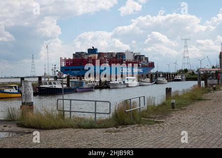 Doel, Belgique, 17 août 2020, le navire à conteneurs Cosco Shipping de Hong Kong navigue à travers le petit port du village polder de Doel en Belgique Banque D'Images