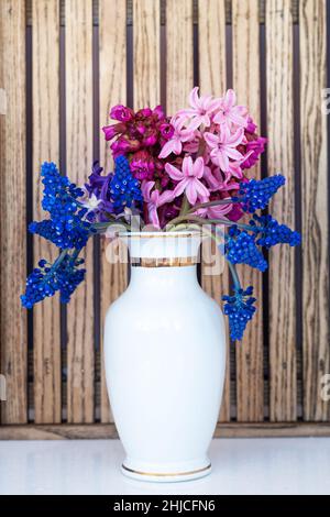 Un bouquet de fleurs de printemps fraîches dans un vase blanc Banque D'Images