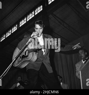 La chanteuse américaine Elvis Presley (1935 - 1977) joue avec intensité de marque à Tampa, en Floride, en 1956. Banque D'Images