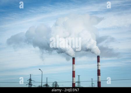 De la vapeur s'échappe des tuyaux de la centrale thermoélectrique en hiver.L'industrie de l'énergie thermique et le concept de pollution environnementale et . Banque D'Images