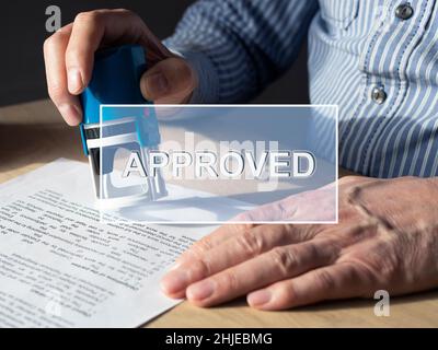 Mot approuvé sur l'image avec les mains de vérification et d'estampage document, contrat. Banque D'Images