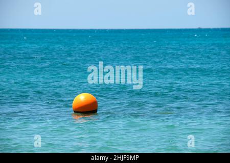 Bouée orange flottant sur les vagues de la surface de la mer.Concept de sécurité de la vie humaine. Banque D'Images