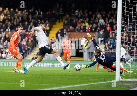 Aleksandar Mitrovic de Fulham (au centre) marque le premier but de son côté du jeu après Daniel Grimshaw, gardien de but Blackpool, lors du match de championnat Sky Bet à Craven Cottage, Londres.Date de la photo: Samedi 29 janvier 2022. Banque D'Images