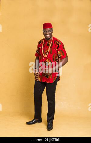 Igbo habillé traditionnellement homme d'affaires debout souriant Banque D'Images