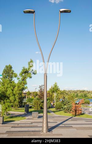 Un poteau d'éclairage LED de rue moderne au parc.Les technologies de l'énergie électrique urbaine.Des économies sur l'éclairage urbain. Banque D'Images