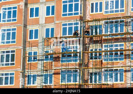 31 mai 2021, Kemerovo, Russie.Installation de fenêtres en plastique et retrait de l'excédent de mousse de montage dans les nouveaux bâtiments résidentiels de plusieurs étages, selectiv Banque D'Images