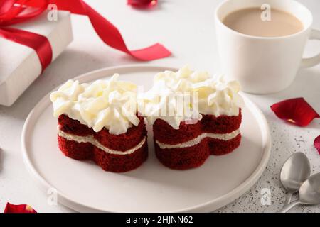 Gâteau de velours rouge en forme de cœur et café pour la Saint-Valentin.Dessert savoureux.Gros plan. Banque D'Images