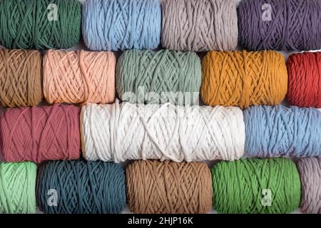 Arrière-plan de fils de macrame colorés. Texture des rouleaux de fils de coton macrame naturels. Pose à plat Banque D'Images