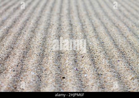 Texture de sable ondulée pour l'arrière-plan. Banque D'Images