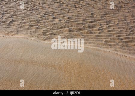 Le sable humide rencontre le sable sec sur la plage résumé Banque D'Images