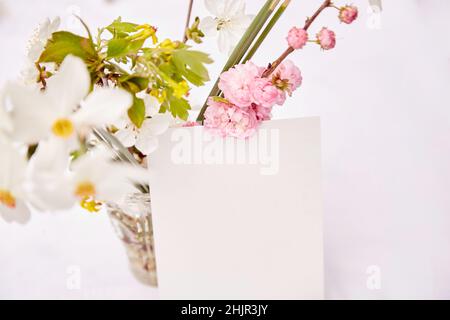 Maquette de carte postale délicate de printemps avec vase de fleurs roses, blanches et jaunes de printemps.Journée de la femme, invitation, fête des mères, mariage, concept de carte d'anniversaire.Concept Naturecore.Coton esthétique. Banque D'Images