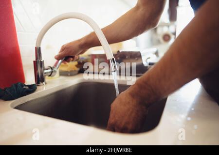 Chef se lavant les mains dans un évier de cuisine de restaurant Banque D'Images