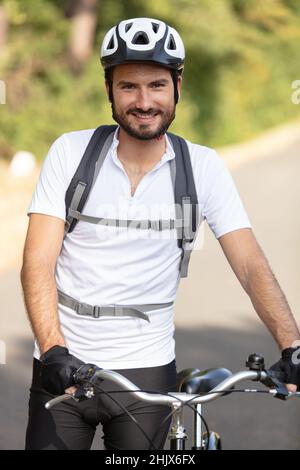 pose d'un cycliste barbu souriant Banque D'Images