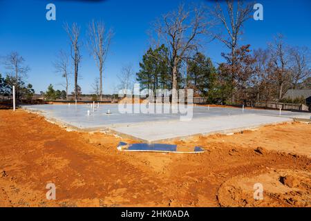 Dalle de béton sur un terrain de terre pour une nouvelle maison. Banque D'Images