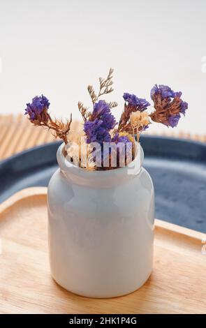 Une fleur sèche dans le vase en céramique blanc Banque D'Images