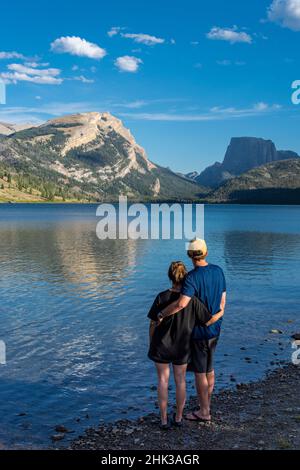 États-Unis, Wyoming.Couple embrassant et profitant de la vue sur White Rock Mountain et Squaretop Peak au-dessus de Green River Lake Banque D'Images