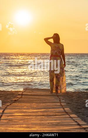 Charmante femme contemplant la mer au coucher du soleil sur la plage de Matala, Crète, Iles grecques, Grèce, Europe Banque D'Images