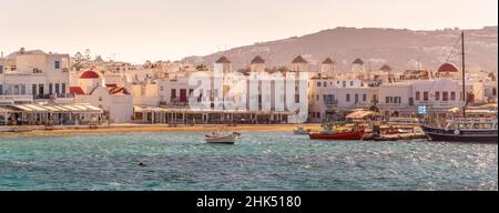 Vue sur les moulins à vent surplombant la ville et le port à l'heure d'or, la ville de Mykonos, Mykonos, les îles Cyclades, les îles grecques,Mer Egée, Grèce, Europe Banque D'Images