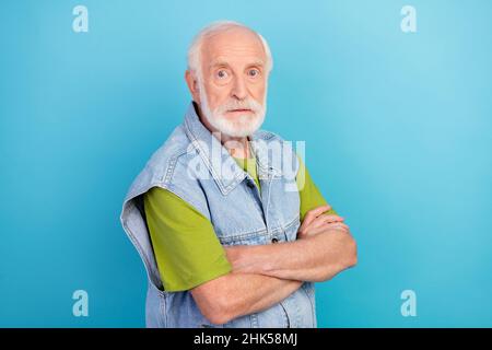 Photo de l'homme sérieux confiant retraité habillé rétro denim veste bras croisés isolé bleu couleur fond Banque D'Images