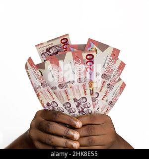 Main noire tenant 3D rendu 200 notes ghanéennes de l'idec. gros plan des mains tenant des billets de monnaie ghanéennes Banque D'Images