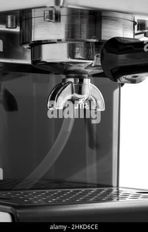 un support avec porte-filtre pour espresso double est installé dans le groupe de tête d'une machine à café professionnelle en acier. Banque D'Images