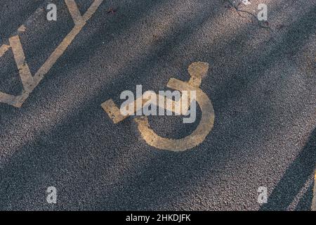 Parking handicapés.Place de parking accessible.Badge bleu.Panneau jaune pour fauteuil roulant au sol Banque D'Images