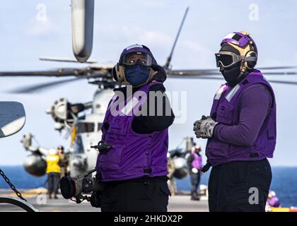 MER DES PHILIPPINES (2 février 2022) Aviation Boatswain's Mate (Fuels) 2nd classe Laquisha Taylor, à gauche, de Fayetteville, N.C.,Et Airman Jacoby Rivers, de Jacksonville, en Floride, tous deux affectés au navire d’assaut amphibie USS America (LHA 6) déployé à l’avant, alimentent un avion de tiltrotor MV-22B Osprey de l’unité expéditionnaire maritime (MEU) de 31st sur le pont de vol du navire.L'Amérique, navire chef de file du America Amphiobie Ready Group, ainsi que le MEU 31st, opère dans la zone de responsabilité de la flotte US 7th afin d'améliorer l'interopérabilité avec les alliés et les partenaires et Banque D'Images