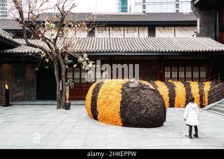 Petite fille se tenant par la décoration artistique de la queue du tigre du nouvel an chinois dans une cour chinoise à Chengdu, Sichuan, Chine Banque D'Images