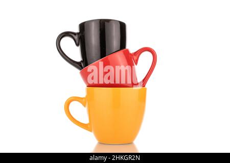 Trois tasses en céramique de différentes couleurs, gros plan, isolées sur du blanc. Banque D'Images