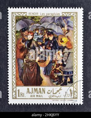 Timbre-poste annulé imprimé par Ajman, qui montre peinture la terrasse par Pierre-Auguste Renoir, vers 1967. Banque D'Images