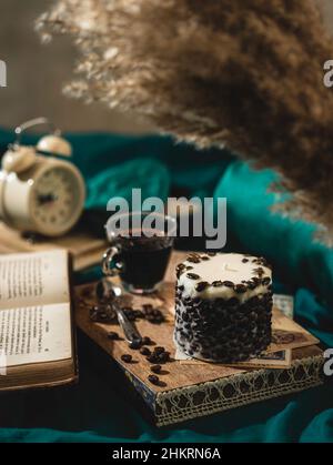 Un plateau en bois avec une bougie et du café parfumés sur le lit.Concept d'hygge.Atmosphère de détente.Style de vie luxueux.Mise au point sélective Banque D'Images