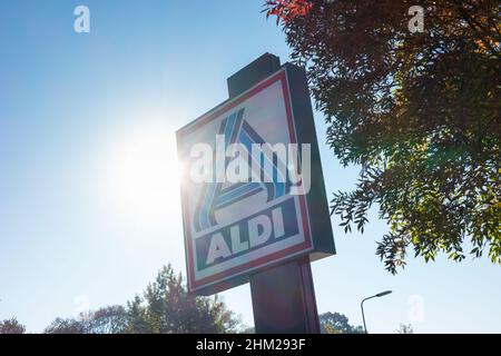 Panneau Aldi (division nord) contre ciel bleu avec lumière du soleil.Aldi est une chaîne mondiale de supermarchés à rabais avec près de 10 000 magasins dans 18 pays Banque D'Images