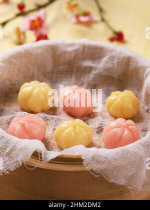 Kkultteok est un gâteau au riz en forme de boule rempli de miel et de sirop de sésame, gâteau traditionnel coréen pour le jour de Chuseok, servi sur un cuiseur vapeur de bambou Banque D'Images