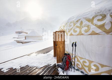 Hôtel et restaurant du complexe de maisons nomades Yurt à la station de ski de Shymbulak à Almaty, Kazakhstan. Porte ouverte en bois à motif ethnique en hiver sno Banque D'Images