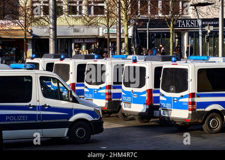 Braunschweig, Allemagne, 8 janvier 2022 : vue arrière d'une voiture de police allemande, fourgonnettes peintes en bleu et blanc Mercedes-Benz, garées sur la chaussée et la manne Banque D'Images