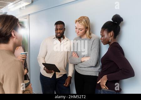 Collègues regardant une tablette numérique pendant une pause-café Banque D'Images