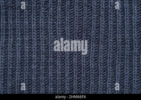 Texture tricotée bleue d'une écharpe ou d'un pull chaud. Banque D'Images