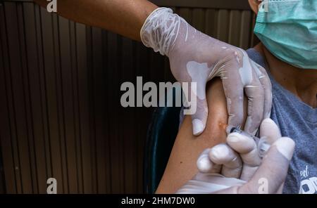 Médecin généraliste vaccinant le vieux patient en clinique avec un espace de copie. Médecin qui donne l'injection à une femme âgée à l'hôpital. Infirmière tenant la seringue bef Banque D'Images