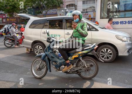 Un chauffeur de taxi moto Grab attend les passagers dans les rues de Ho Chi Minh-ville (Saigon), du sud du Vietnam, de l'Asie du Sud-est Banque D'Images