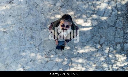 Un homme contrôle son drone et prend des photos et des vidéos. Vue aérienne du dessus, technologie et concept de style de vie. Banque D'Images