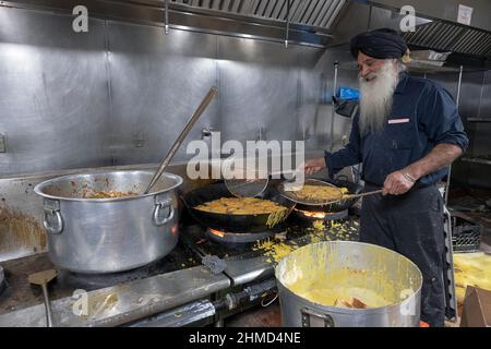 Un volontaire dans un temple sikh prépare de la nourriture végétarienne qui sera fournie à quiconque demande. À South Richmond Hill, Queens, New York. Banque D'Images