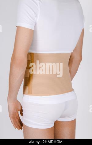 Corset lombaire orthopédique sur le corps humain.Renfort arrière, ceinture de soutien de la taille pour le dos.Correcteur de posture pour rachis de la clavicule arrière.Hernie post-opératoire Banque D'Images