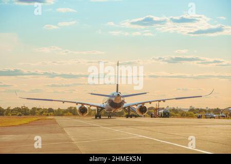 Vue arrière d'un avion ravitaillé d'un camion-citerne par une journée ensoleillée et un beau ciel Banque D'Images